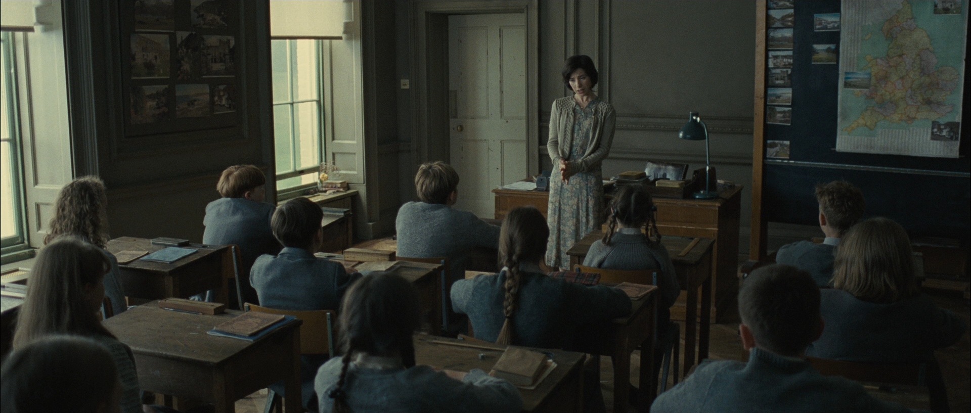 Students and a teacher in a classroom at Hailsham, from the movie adaptation of Never Let Me Go