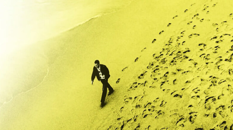 Mersault walking on the beach in Algeria, from the cover of 'The Mersault Investigation'