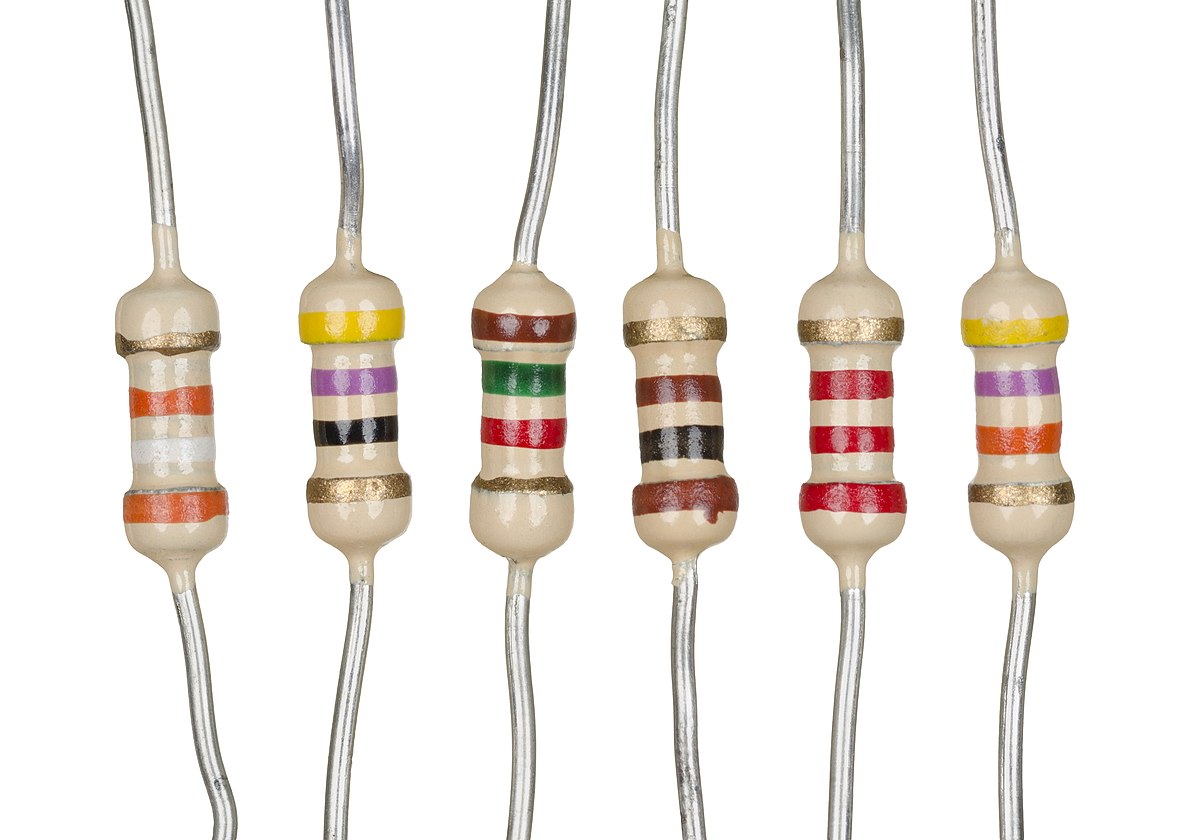 A few light-brown cylinders mounted on silver wires that come in on the circular ends of the cylinder. Each has a different series of colored rings on it. Each cylinder has a wider part at the top and bottom where they join the wires, and their shapes are a bit blobby rather than being exactly cylindrical